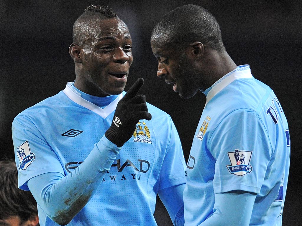 Mario Balotelli with Yaya Toure