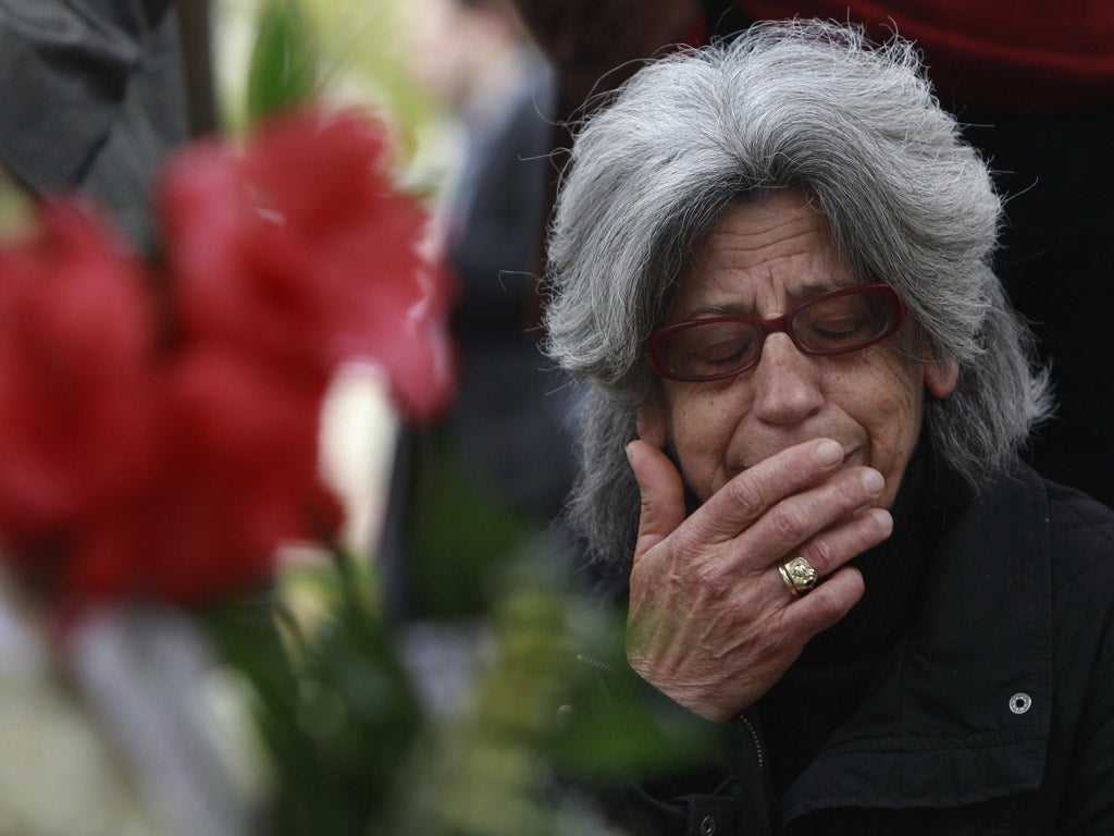 A woman cries at the spot where Dimitris Christoulas killed himself