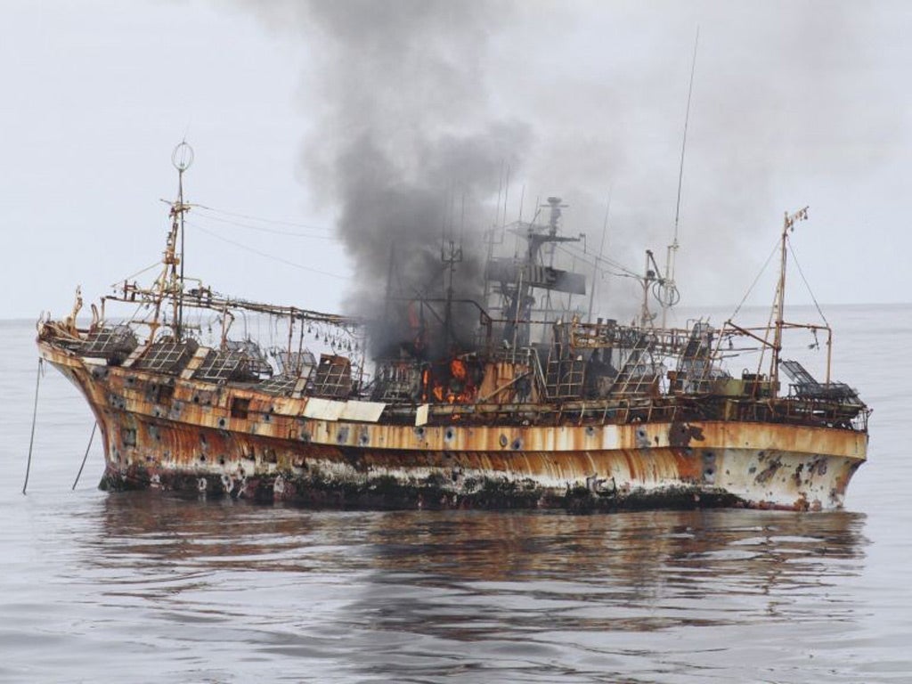 Japanese fishing vessel, "Ryou-Un Maru", shows significant signs of damage after U.S. Coast Guard Cutter Anancapa fired explosive ammunition into it