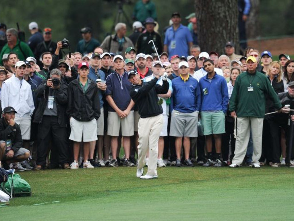 Lee Westwood hits an approach shot on the second hole yesterday