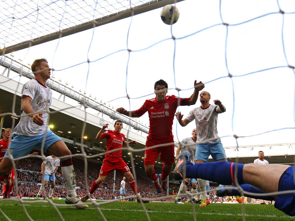 Head boy: Luis Suarez nods in to ease some of the pressure at Anfield