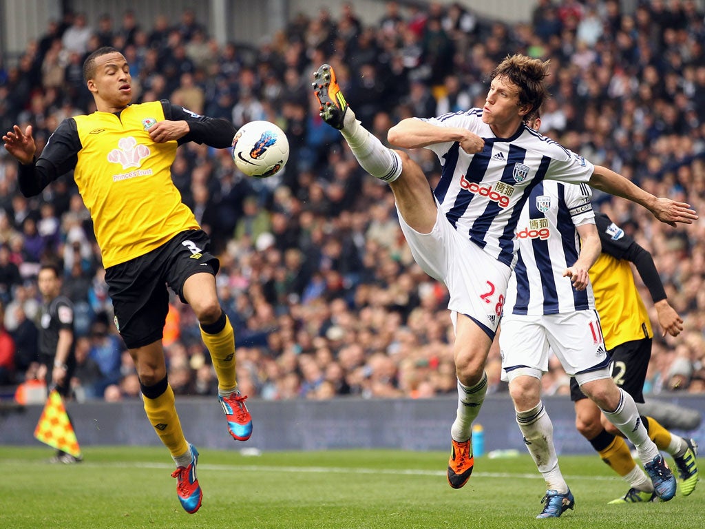 Boots Flying: Martin Olsson of Blackburn and West Bromwich's Billy Jones battle for the ball