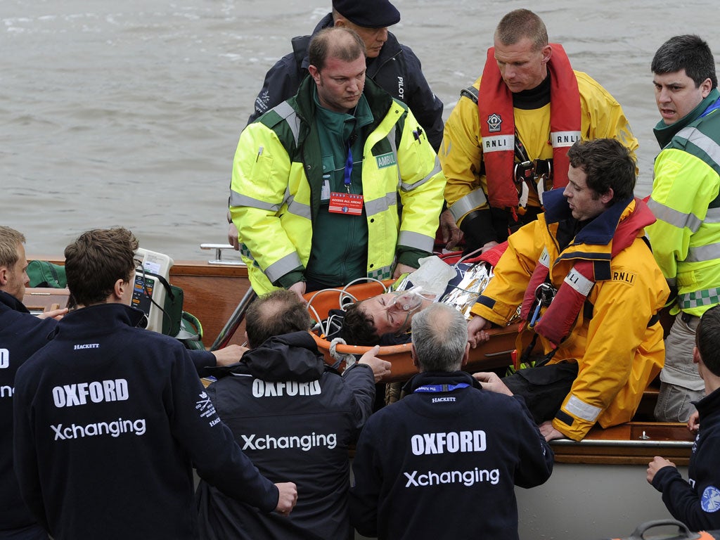 Paramedics carry Alex Wood from the boat