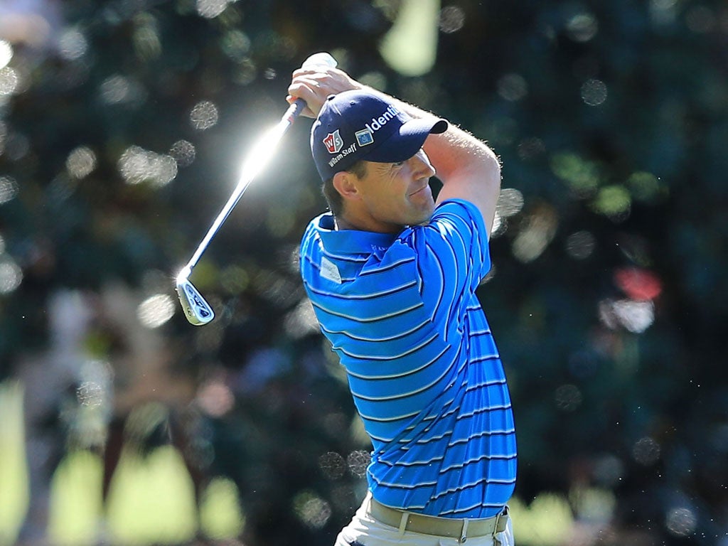 Glimmer of hope: Padraig Harrington plays his second shot to the 18th green