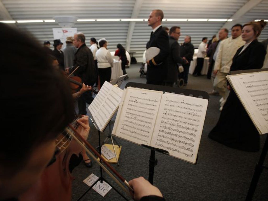 A band plays the tune 'Viceroy Tea' as passengers queue to check in for the MS Balmoral Titanic memorial cruise in Southampton