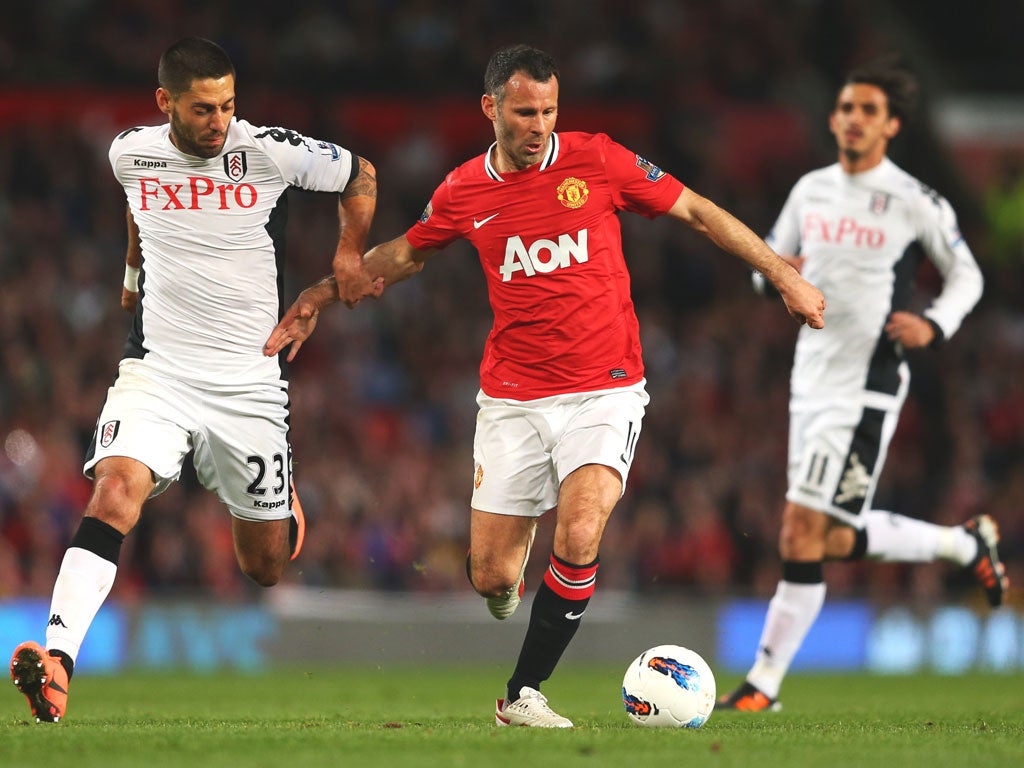 Ryan Giggs holds off Clint Dempsey, of Fulham, last
month