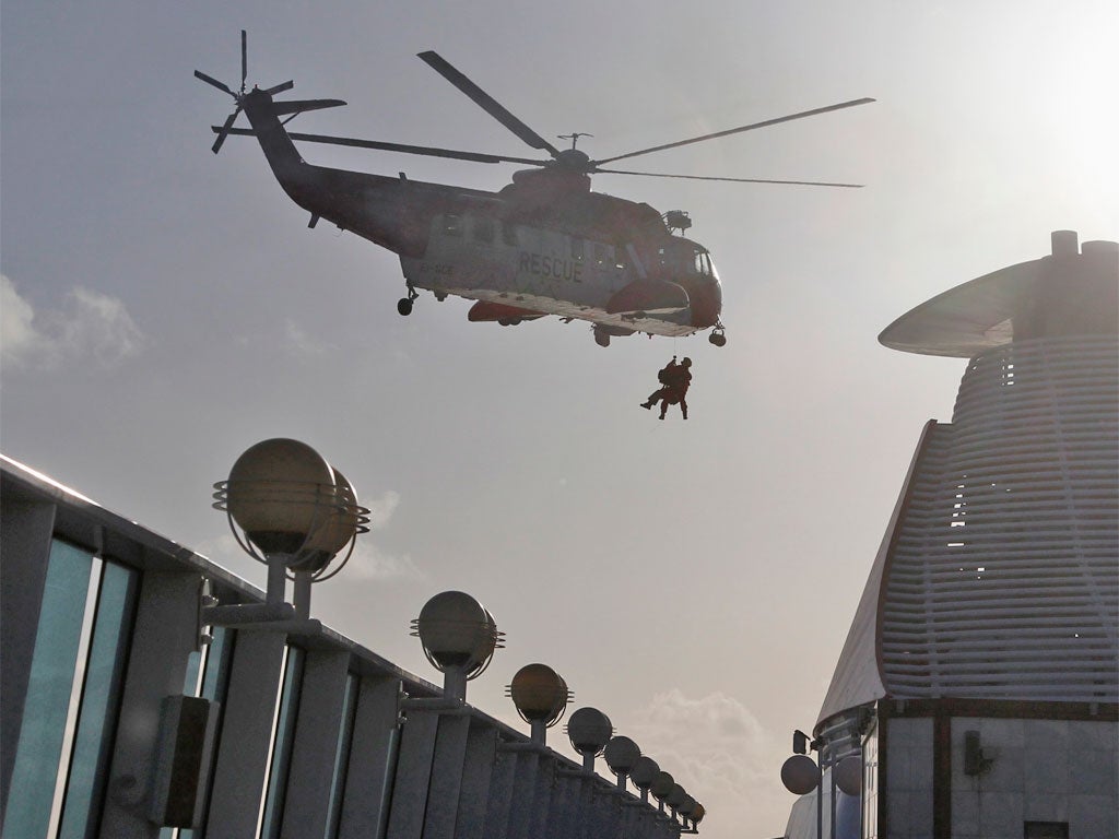 An Irish Coast Guard helicopter winches a man suffering from a heart ailment from the MS Balmoral