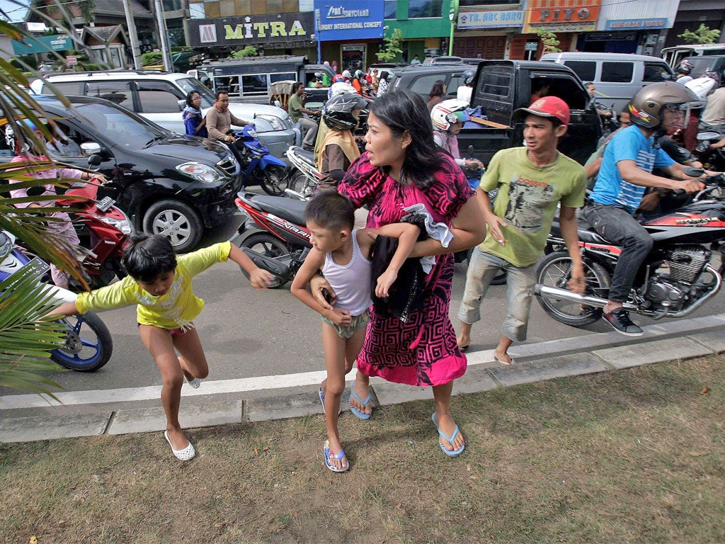 Residents of Banda Aceh flee after a magnitude 8.6 earthquake sparked a tsunami warning that extended to the coasts of India and Africa