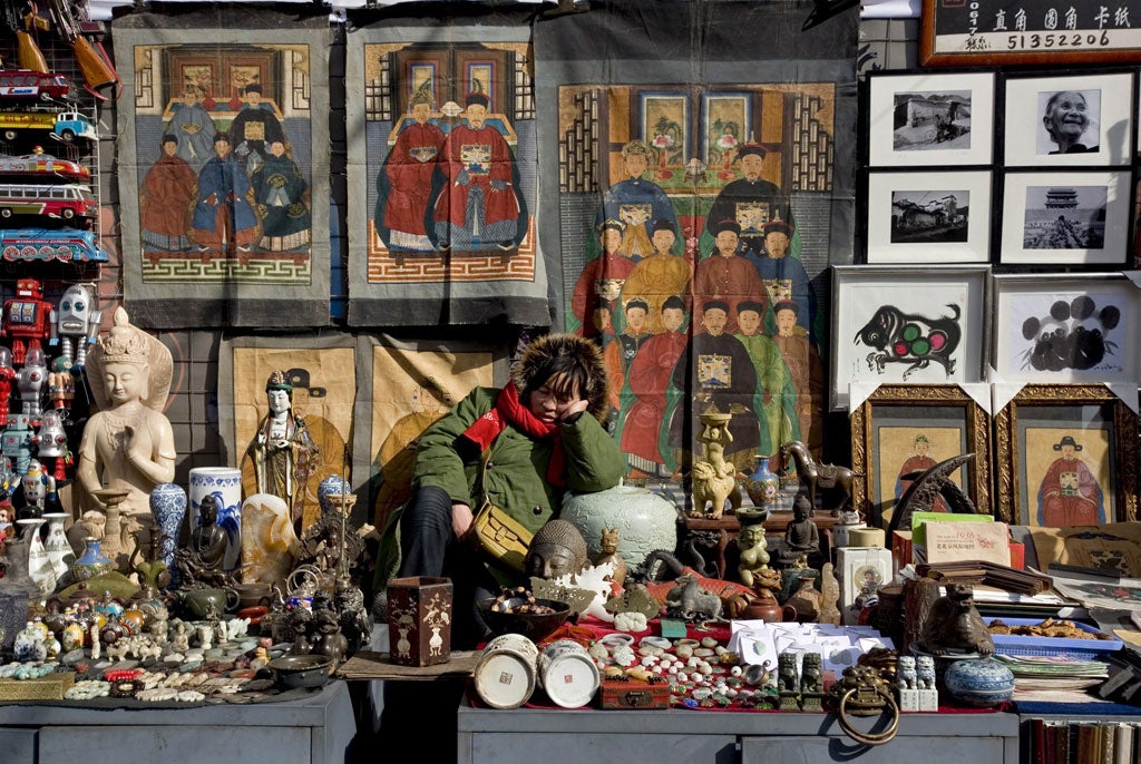 Treasures for export, or bound to stay at home? Vendor at a street stall in Beijing