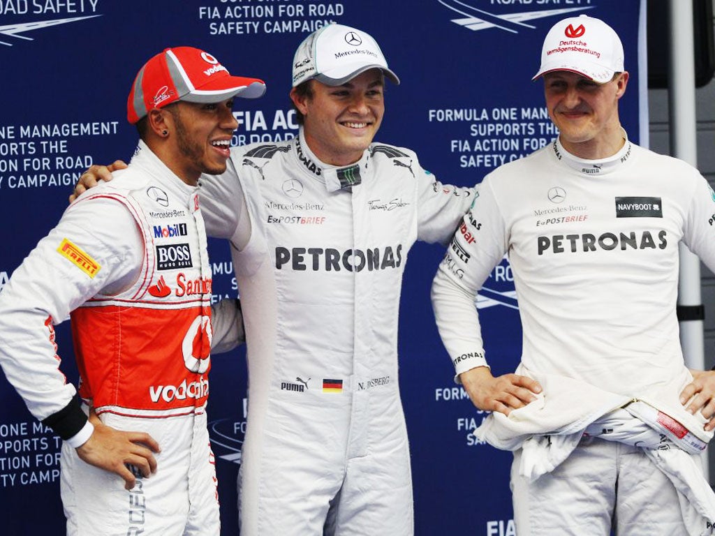 Mercedes driver Nico Rosberg, centre, celebrates with teammate Michael Schumacher, right, and Lewis Hamilton of McLaren after winning the qualifying session the Chinese Grand Prix in Shanghai