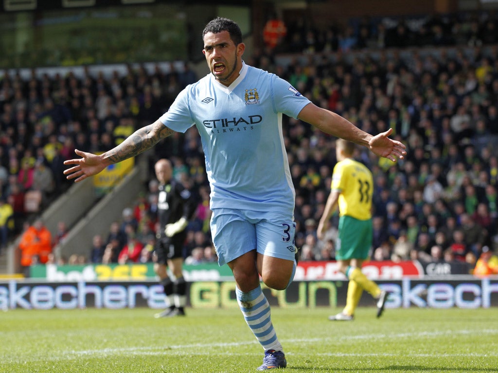 Carlos Tevez celebrates his third goal