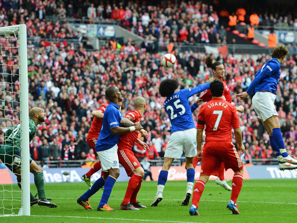 Andy Carroll rises above the Everton defence to score the winner