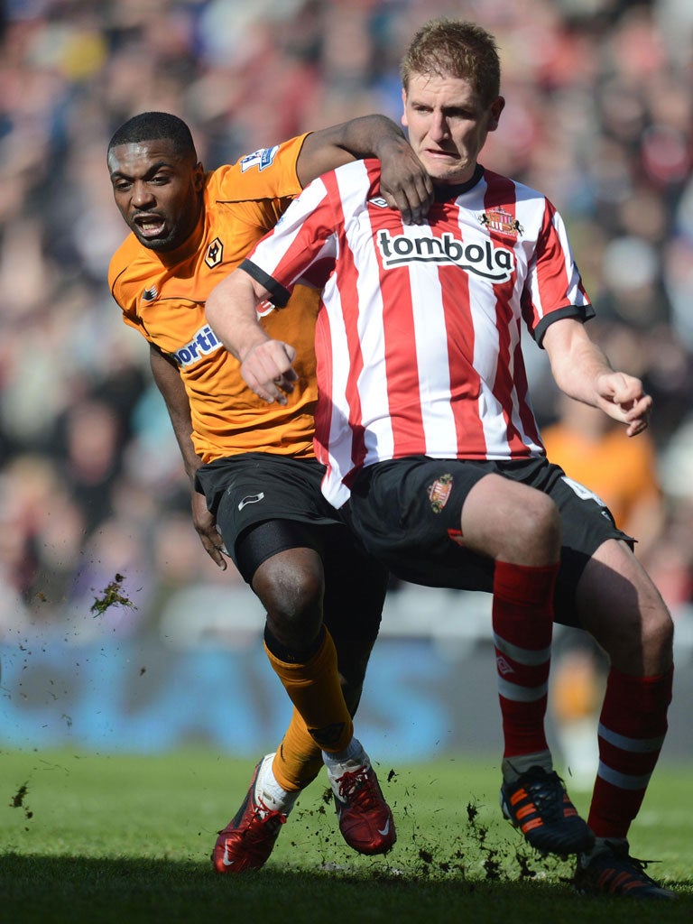 Locked horns: Sylvan Ebanks-Blake of Wolves (left) battles with Michael Turner