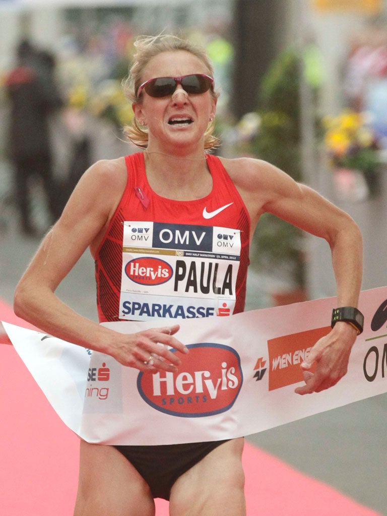 Paula Radcliffe grimaces as she crosses the line in
Vienna