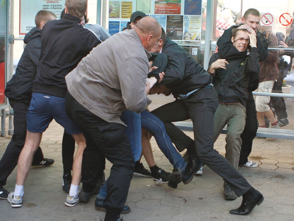 Plain-clothes policemen arrest protesters