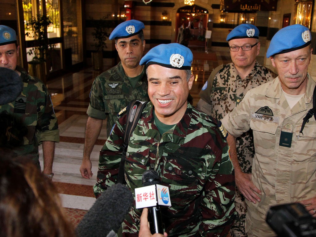 The UN team arrives in Damascus yesterday after another weekend of shelling wrecked buildings in Homs