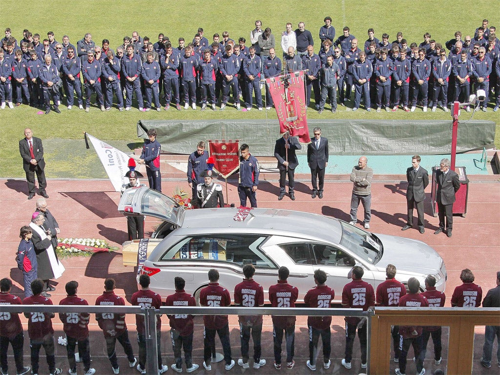 Livorno players with the hearse bearing Piermario Morosini at the club's Armando Picchi stadium yesterday