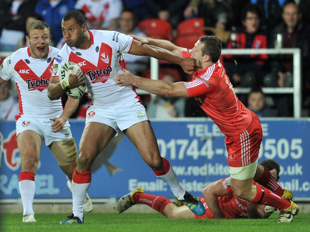 St Helens' Francis Melli holds off Widnes' Cameron Phelps