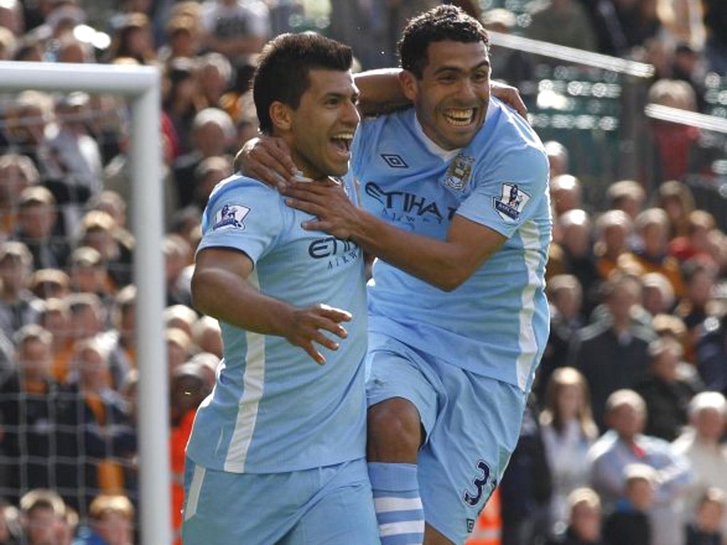 Sergio Aguero (left) is congratulated on scoring by Carlos Tevez
