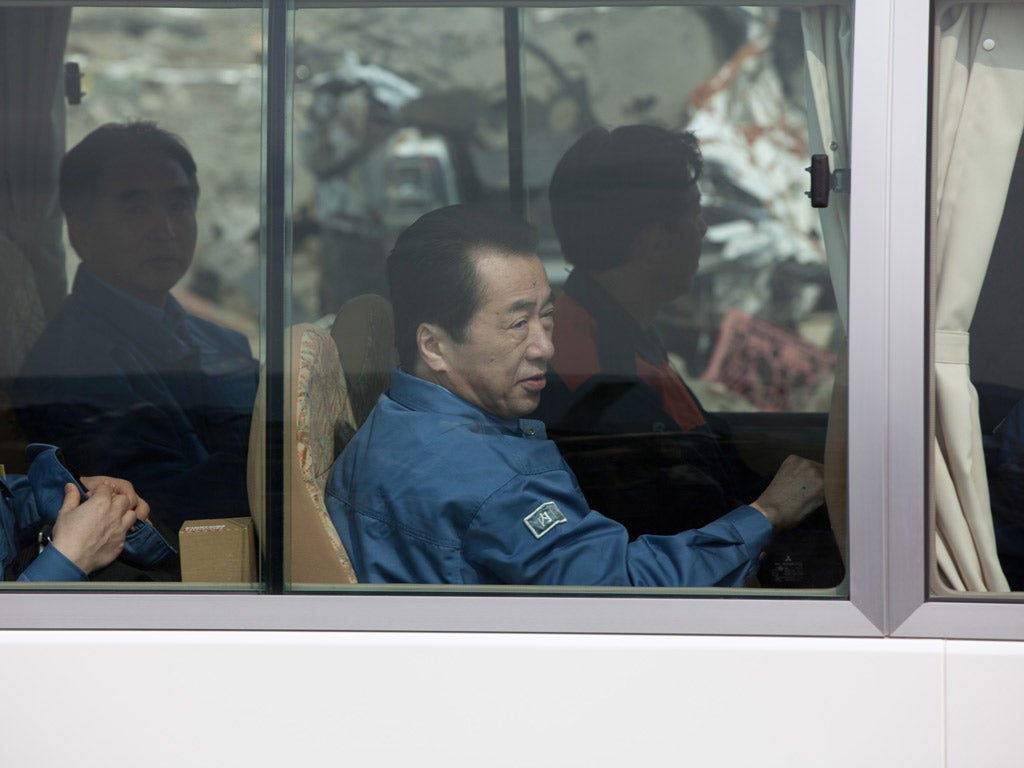 Prime Minister Kan takes a bus tour of the disaster zone