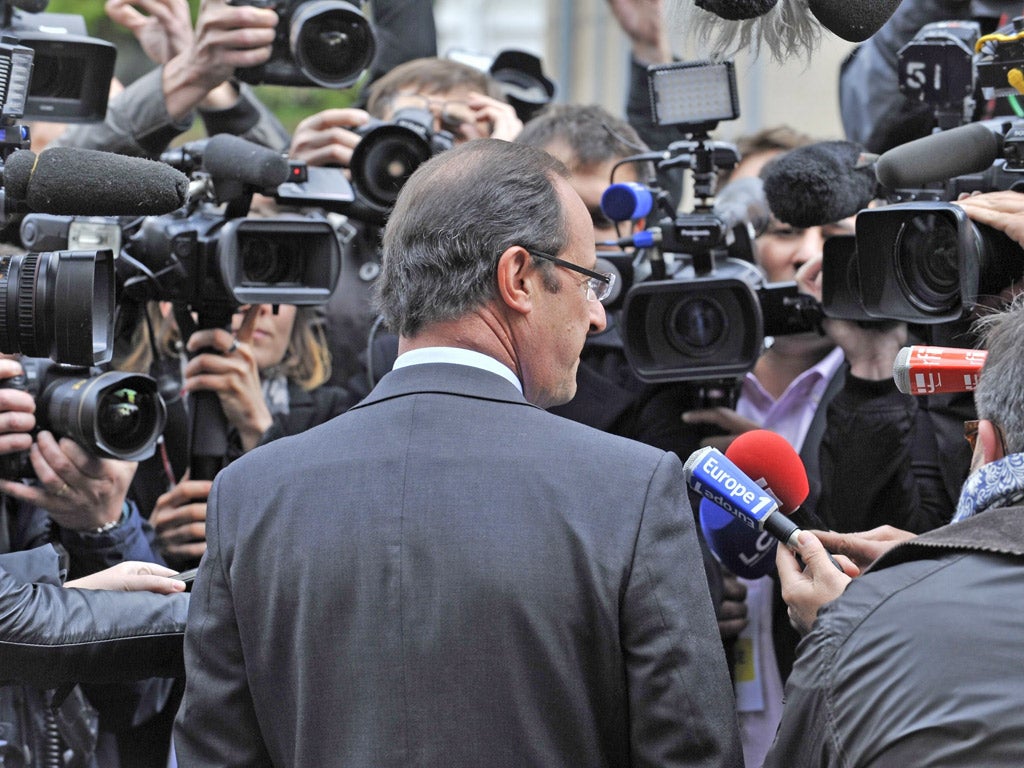 François Hollande greets the media after voting yesterday