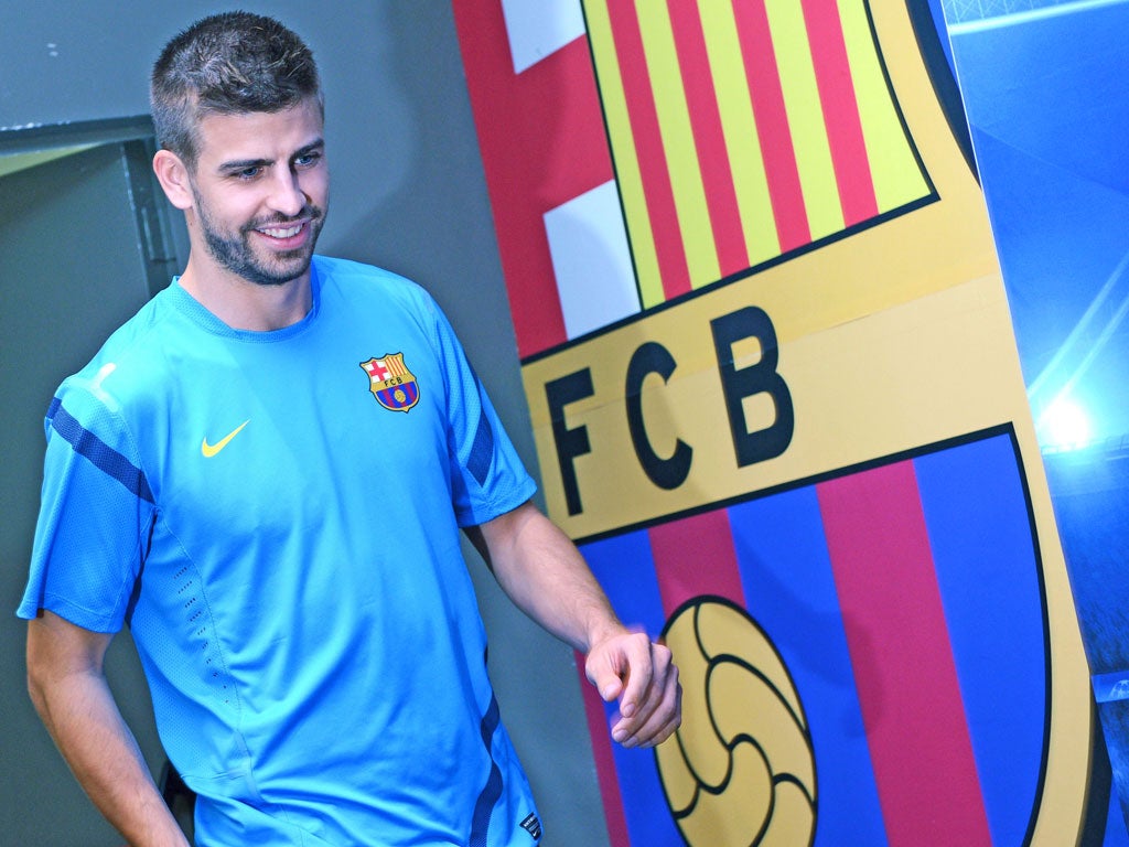Gerard Pique prepares to face the press yesterday in
upbeat mood