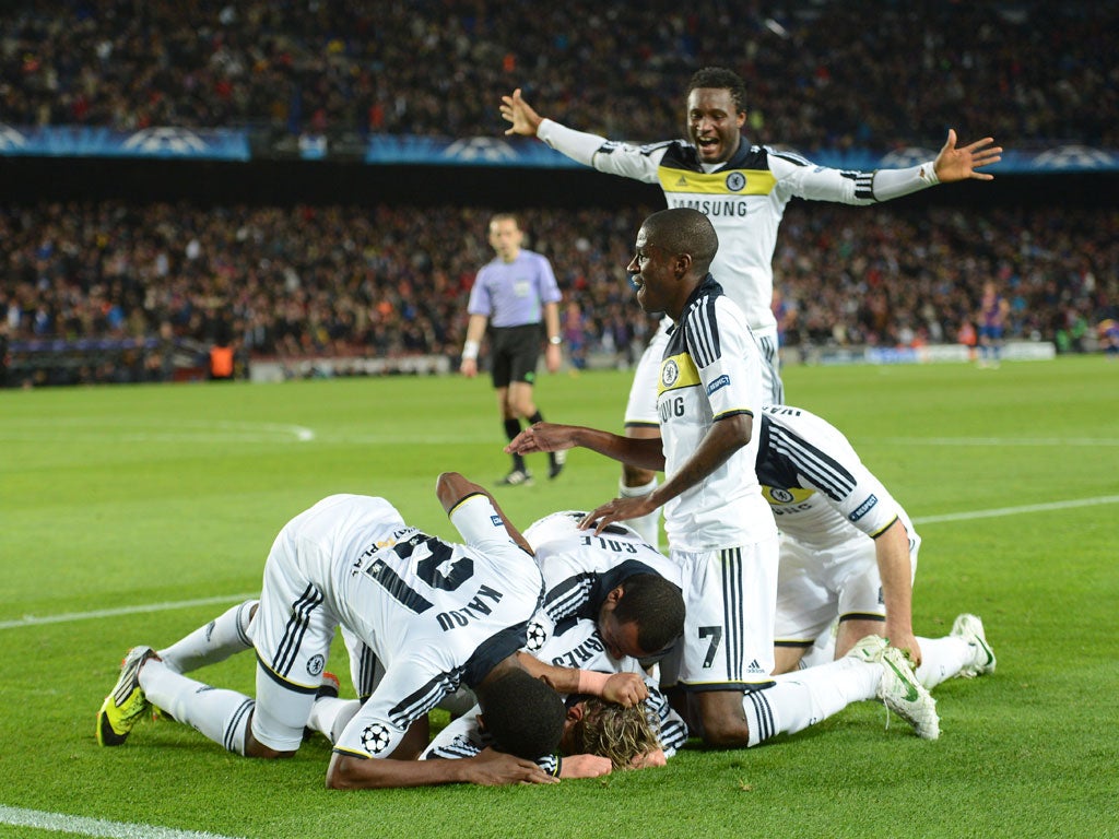 Torres is mobbed after scoring Chelsea's second against Barcelona