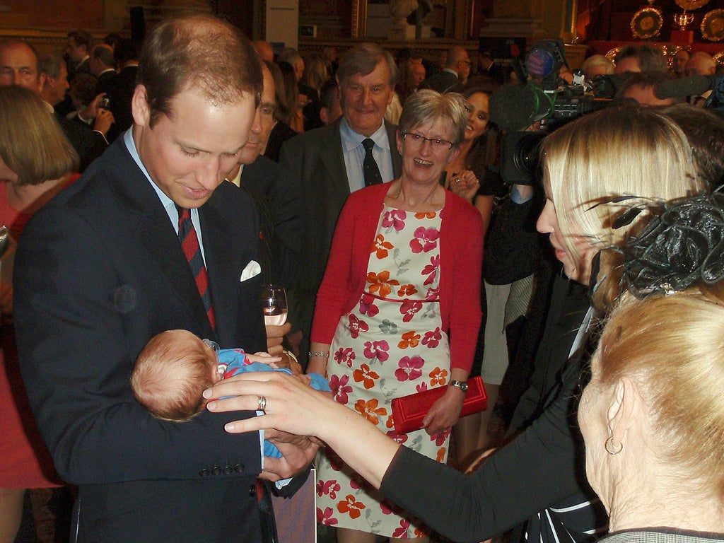 Left holding the baby: Prince William held the infant son of one of the adventurers at an event in Londob