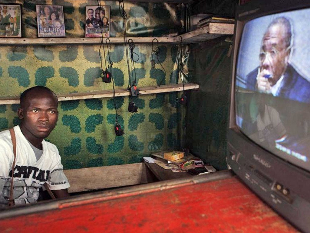 A street vendor in Freetown, Liberia, watches coverage of Charles Taylor being convicted of
war crimes at The Hague yesterday
