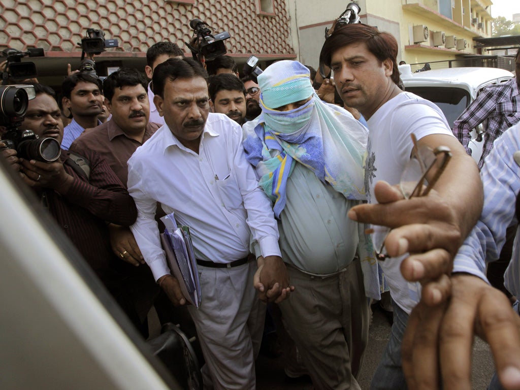 Syed Mohamed Kazmi, centre, was arrested in Delhi in March