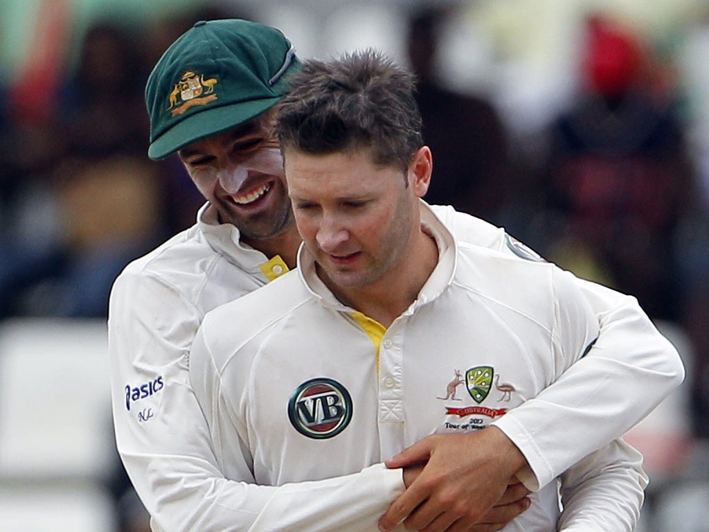 Australia's Michael Clarke (right) is hugged by team-mate Nathan
Lyon after taking the wicket of tailender Ravi Rampaul for 11