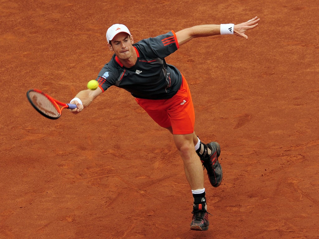 Andy Murray stretches to make a return during his straight-sets defeat