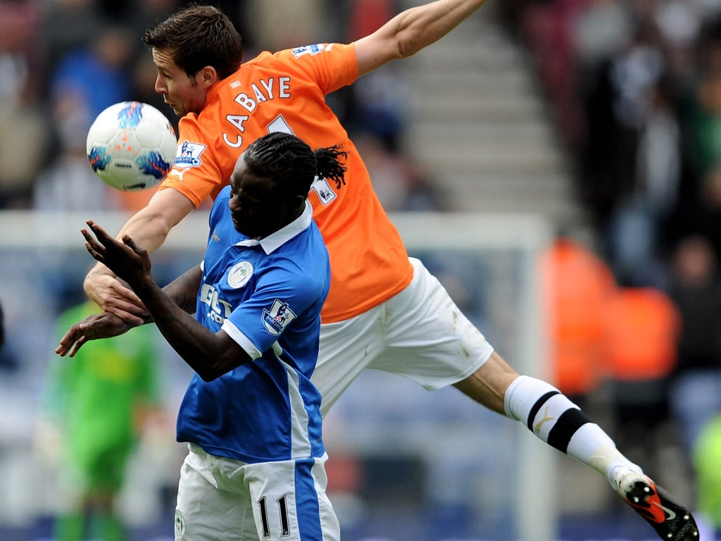 Wigan's Victor Moses tangles with Yohan Cabaye