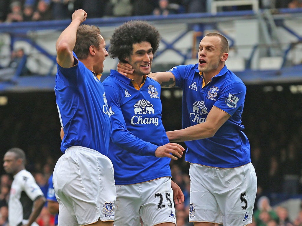 Fun boy three: Marouane Fellaini, centre, is mobbed after making it 2-0
