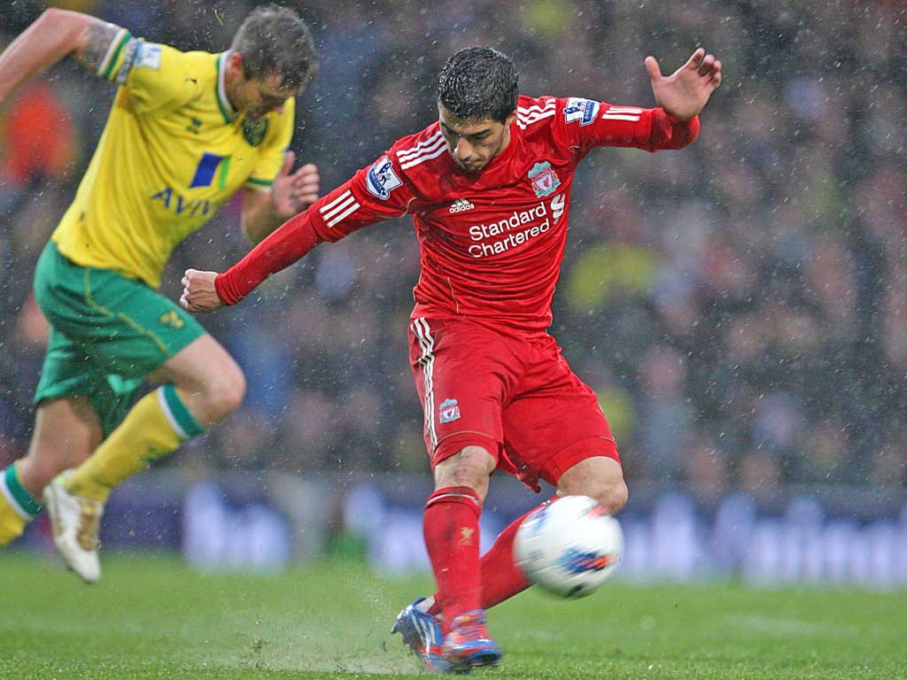 Liverpool’s Luis Suarez completes his hat-trick with a long range effort