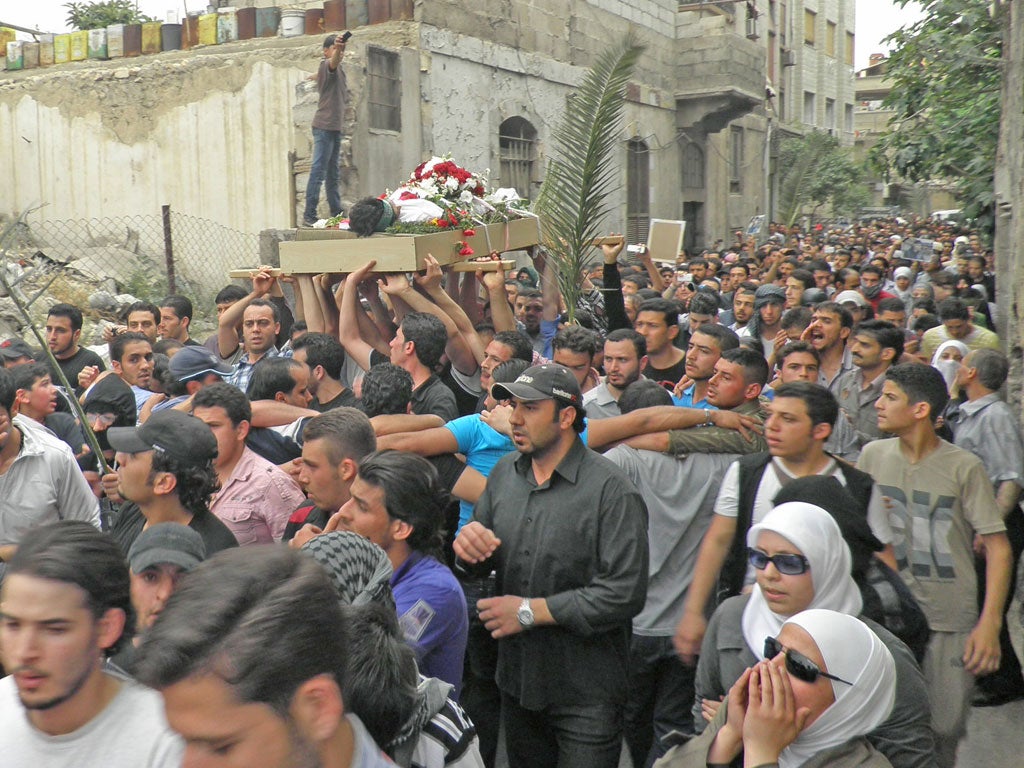 Anti-regime protesters carry the body of activist Nour al-Zahraa, 23, who was shot on Sunday