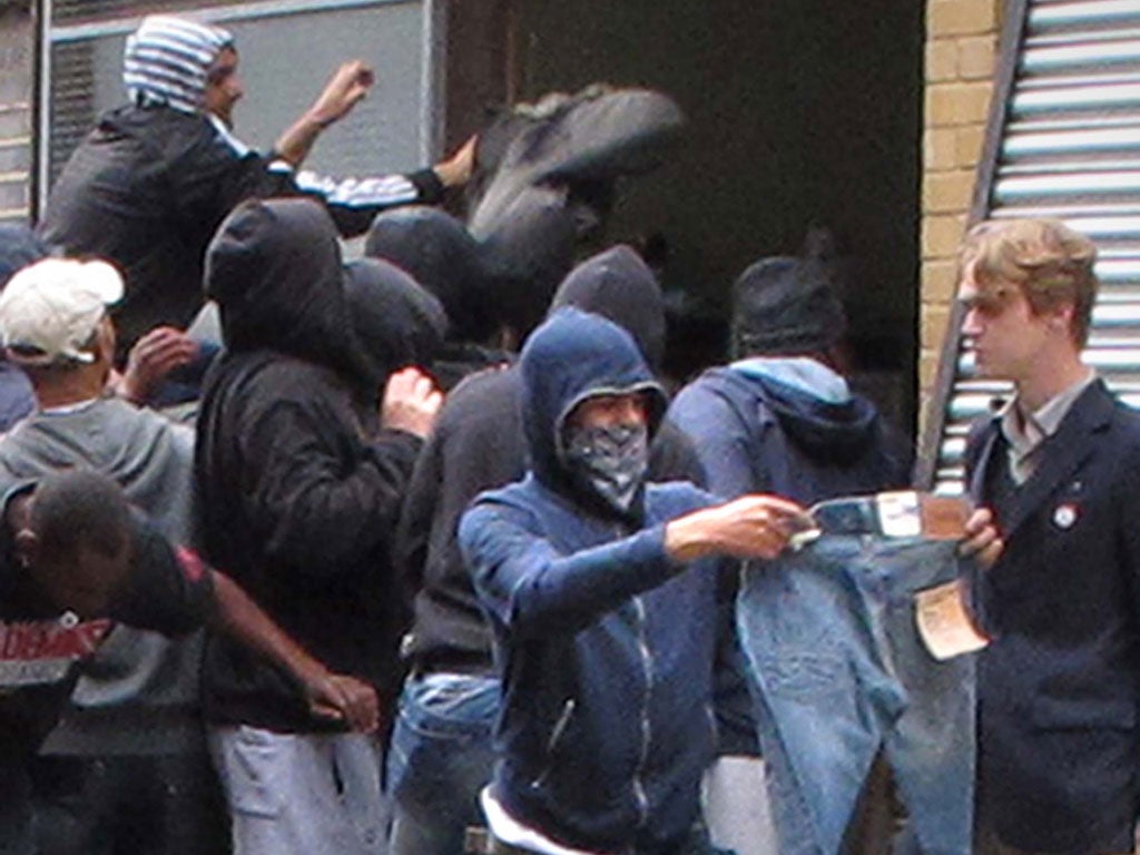 Youths loot a Carhartt store in Hackney, east London, during the riots