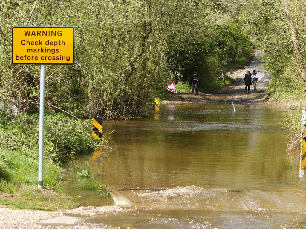 A flooded road in Hampshire where a man and his dog died yesterday after being swept away in their car by fast-flowing floodwater