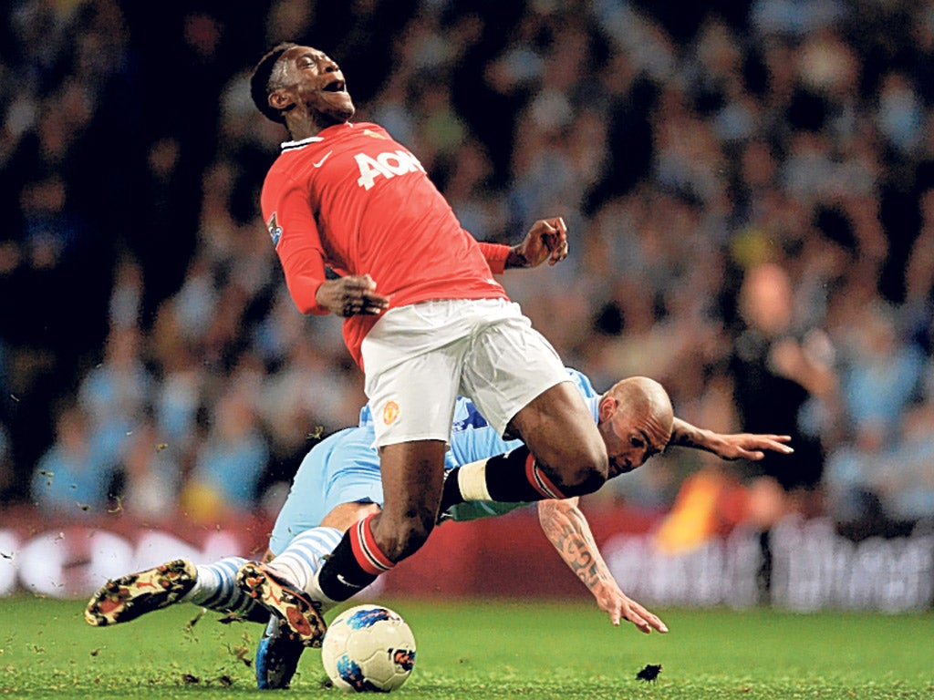 Nigel de Jong takes down Danny Welbeck to earn a yellow card and spark the managers’ argument