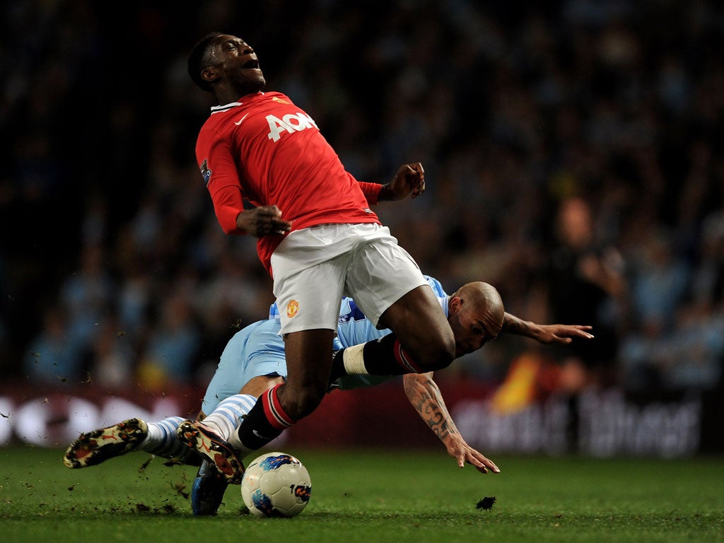 Danny Welbeck is challenged by Nigel de Jong