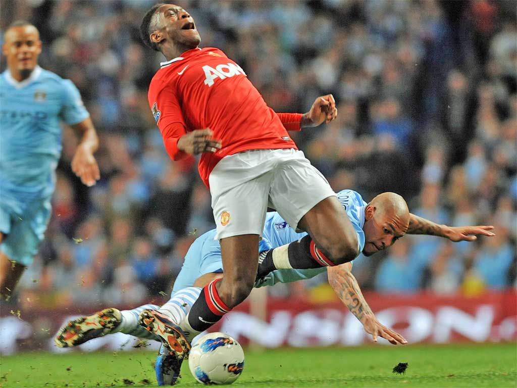 Danny Welbeck goes down under Nigel de Jong's challenge