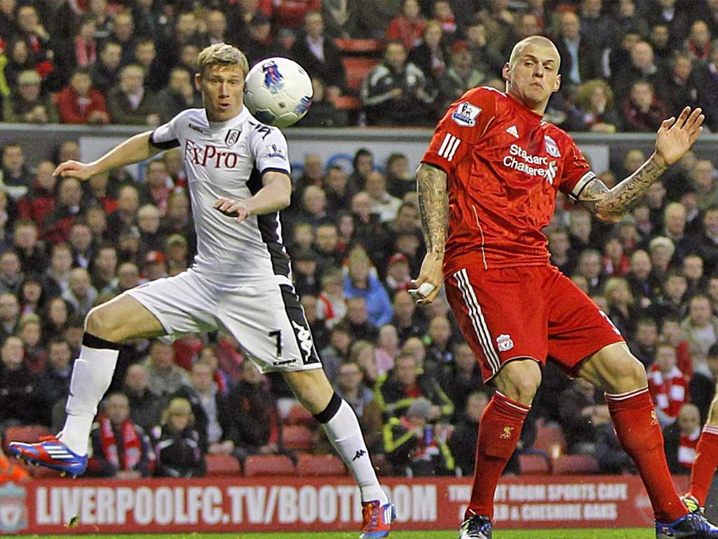 Martin Skrtel (right) deflects the ball towards his own goal for Fulham's winner last night