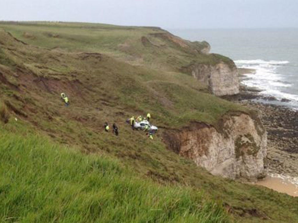 Emergency services rushed to the scene at Flamborough, East Yorkshire, as the BMW stopped 'precariously close' to a 100ft (30m) drop