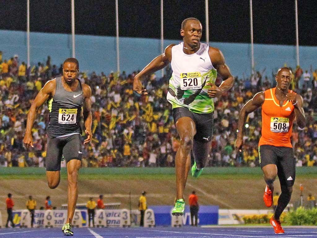 Usain Bolt (left) wins the 100m at the Jamaica Invitational