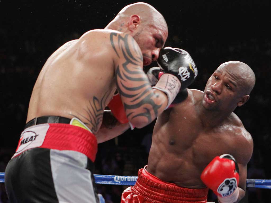 Floyd Mayweather connects with his right to hurt Miguel Cotto in his bloody but clear-cut victory in Las Vegas