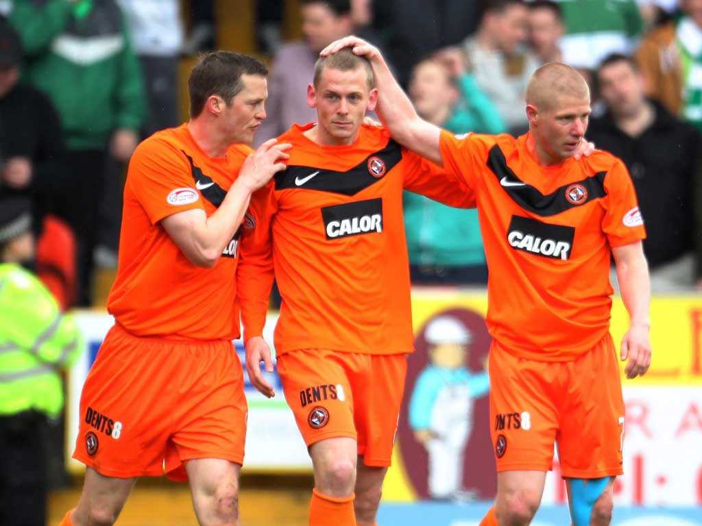 Dundee United’s Scott Robertson is congratulated on his winner