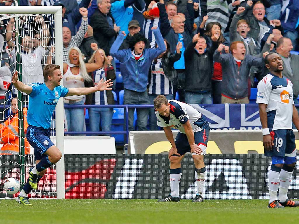 West Bromwich’s James Morrison (left) celebrates the equaliser that
leaves Bolton’s players feeling down and out yesterday