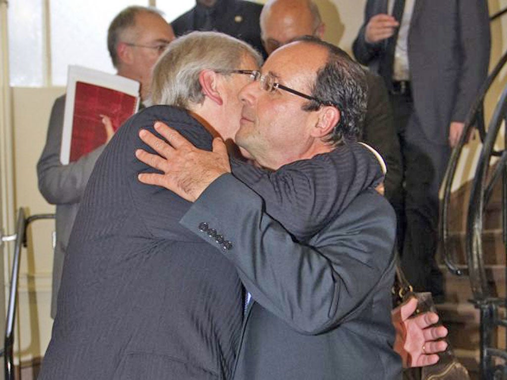 The newly elected French President, François Hollande, greets the Eurogroup chairman and Luxembourg’s Prime Minister Jean-Claude Juncker