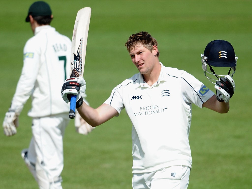 Ollie Rayner raises his bat on reaching his century at Trent Bridge