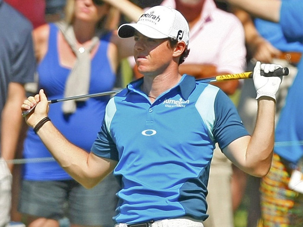 Rory McIlroy watches with dismay as he goes into the water at the 16th at Sawgrass yesterday